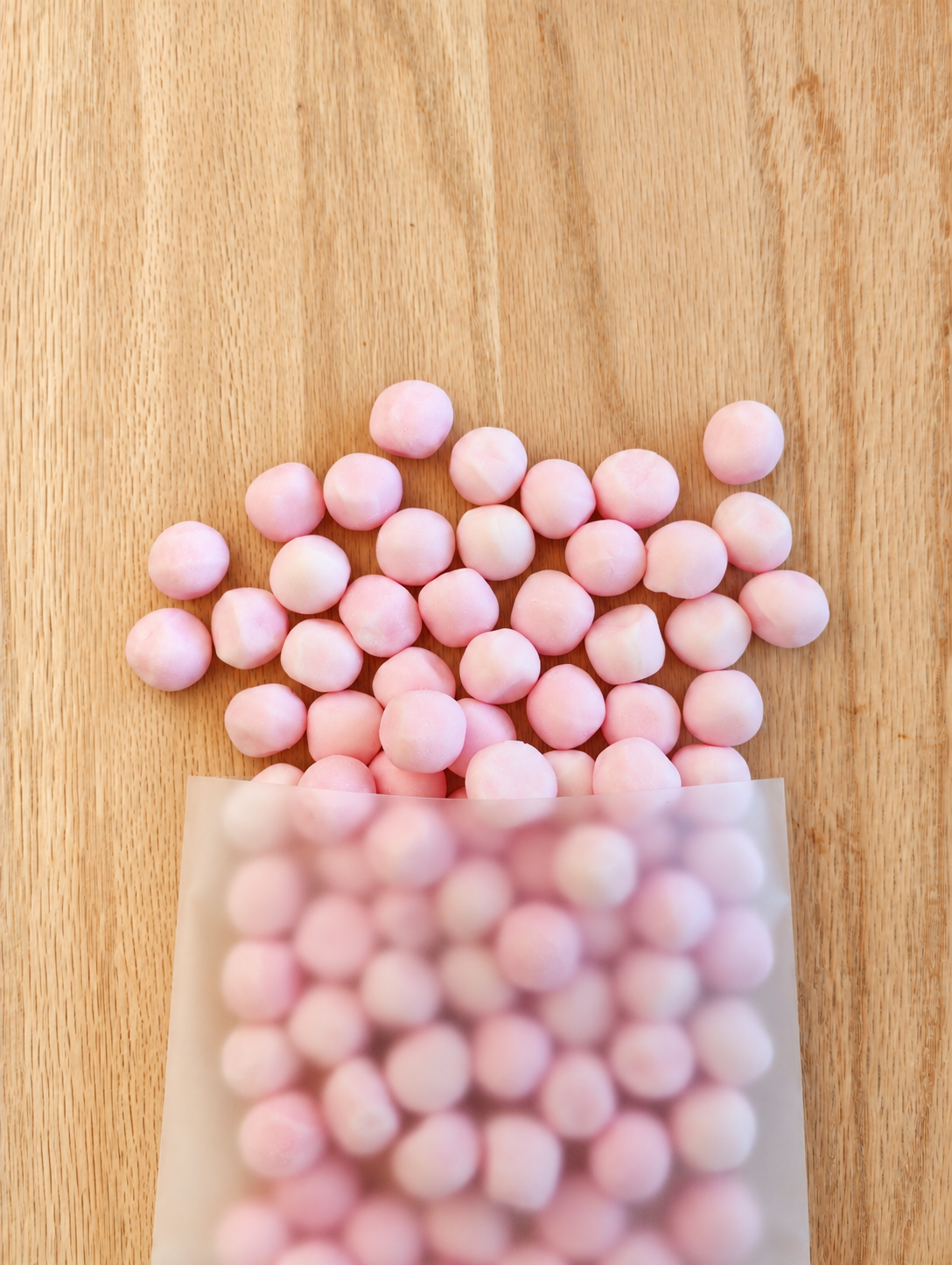 Strawberry Bonbons in a frosted candy bag on light wood