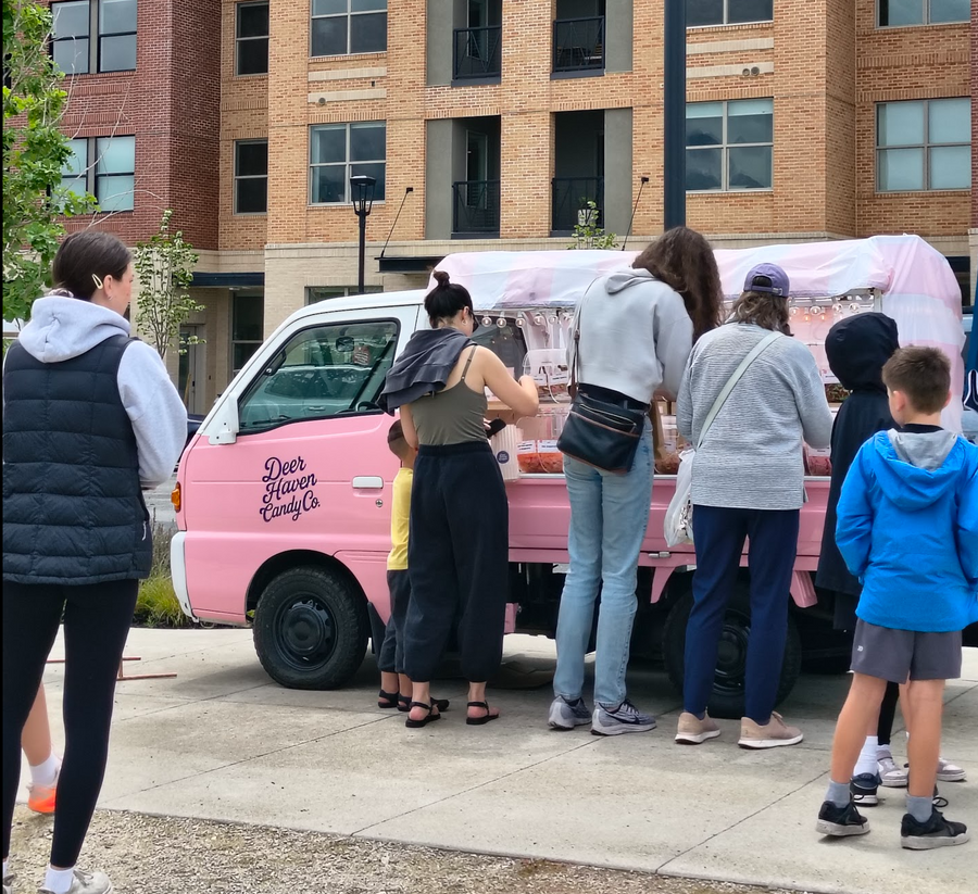 Pink candy truck at an evening event